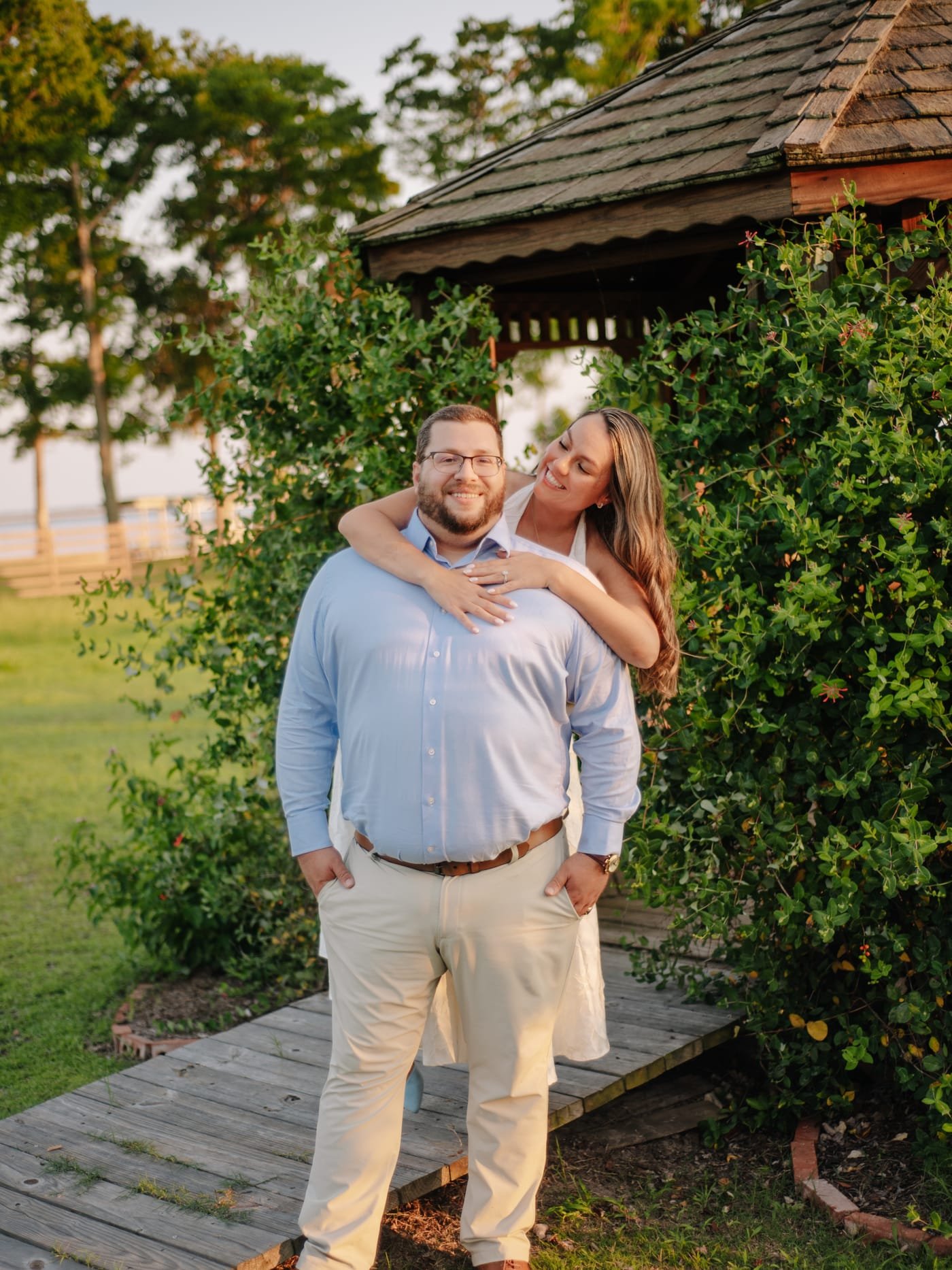 Katherine with her arms around Pierce's shoulders on the gazebo boardwalk.